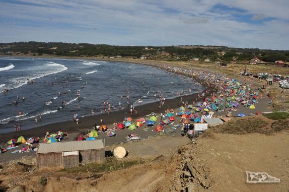 Praia de areias escuras e movimentada em Pichilemu, no litoral central do Chile
